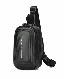 Detail of black hard shell chest bag with carbon fiber texture and USB charging port