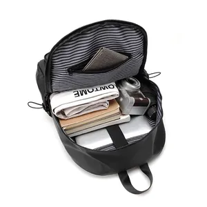 Black travel backpack with large capacity interior showing laptop and camera storage