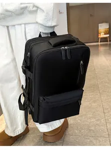 Close-up of black travel backpack with USB port, durable handle and multiple zipper compartments