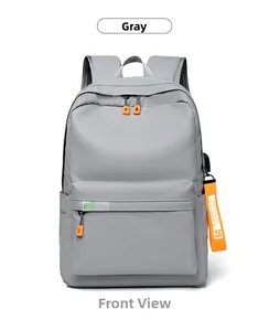 Detail of grey backpack with USB charging port and orange decorative strap