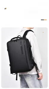 Detail of expandable black travel backpack with side USB port and waterproof fabric