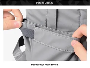 Close-up of durable gray nylon backpack side with reinforced elastic storage strap details