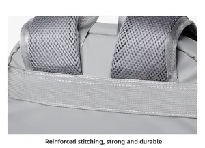 Detail of reinforced stitching and breathable mesh shoulder strap on gray backpack