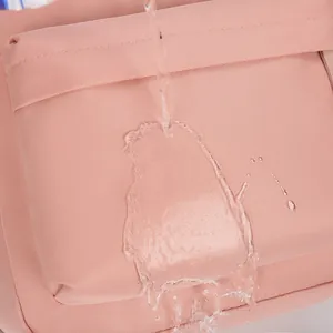 Pink waterproof travel backpack with splash-resistant fabric and textured finish