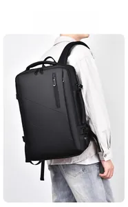 Close-up of black travel backpack showing integrated USB charging port and side buckle detail