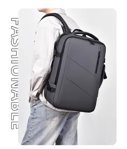 Side view of a sleek expandable grey business backpack worn by a model in a studio setting