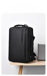 Detail view of black travel backpack with side buckle, USB port and laptop compartment