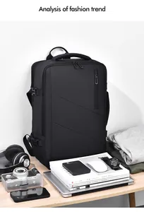 Close-up of black travel backpack with business tech accessories on wooden surface