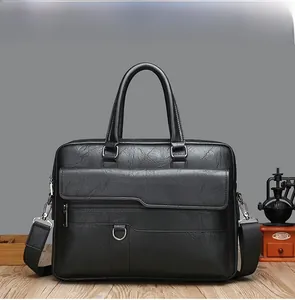 Detail view of a black vintage business briefcase with leather texture and shoulder strap