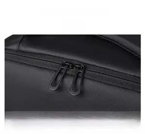 Close-up of smooth dual-way metal zippers on a premium black travel laptop backpack
