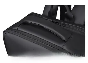 Close-up of the reinforced handle and premium zipper on this black business travel backpack