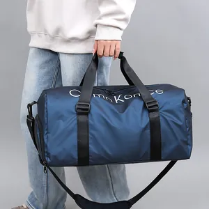 Sac de sport cylindrique bleu marine avec compartiment chaussures et bandoulière