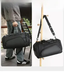 Close-up of durable black travel bag featuring breathable mesh pocket and padded straps