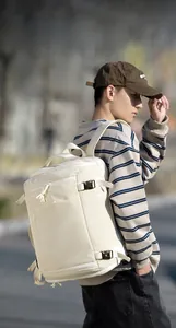 Close-up of beige travel backpack with water-resistant fabric and reinforced handles