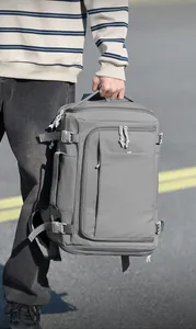 Side view of grey travel backpack showing adjustable compression straps and side handle