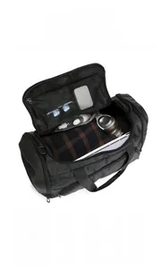 Detailed internal view of spacious black travel bag with organized compartments and mesh pockets