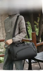 Outdoor shot of the versatile black travel bag with adjustable straps and side mesh pocket