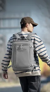 Detail showing waterproof oxford fabric and side adjustable buckles on gray travel backpack
