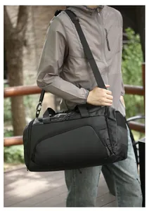 Detail of multi-functional black sports duffel bag with side mesh pocket and sturdy straps
