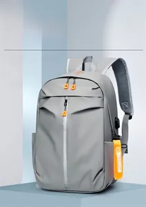Detail of grey waterproof backpack showing USB charging port and breathable mesh strap