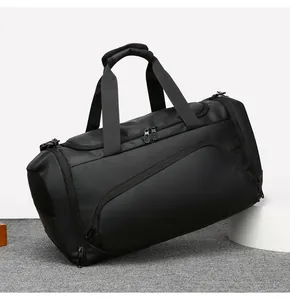 Detail view of large black gym bag showing reinforced handles and side mesh pockets