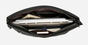 Internal view of black canvas laptop bag showing multi-layer compartments and large capacity