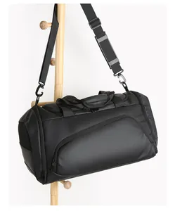 Detail of waterproof matte black duffel bag with padded shoulder strap and side vent