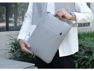 Close-up of a grey laptop bag showing high-density fabric texture and front pocket