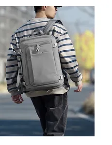 Outdoor shot of a grey waterproof travel backpack with adjustable side straps and pockets