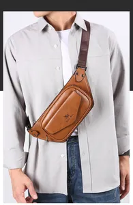 Detail of vintage brown leather waist bag for men featuring the Dais Bear logo and strap