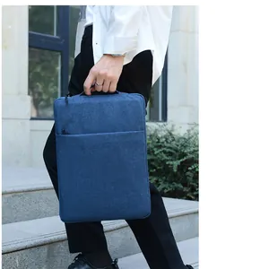 Detail of dark blue laptop sleeve with handle and front zipper pocket in use