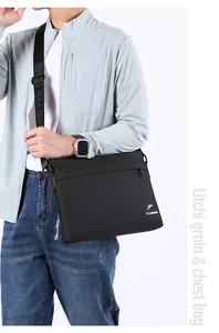 Close-up of litchi grain texture and kangaroo logo on black men's shoulder bag