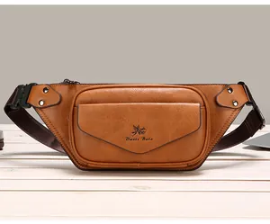 Detail of vintage brown leather waist bag with front flap pocket and logo on wood