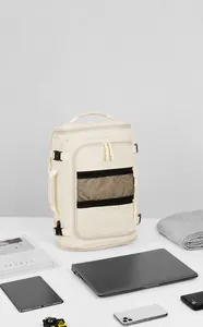Detail view of large capacity beige travel backpack with laptop and tech accessories