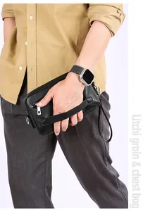 Detail van zwarte litchi-leertextuur op de heren crossbody tas voor zakelijk gebruik