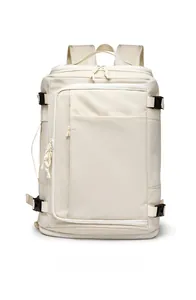 Close-up of beige travel backpack featuring waterproof zippers and side handles