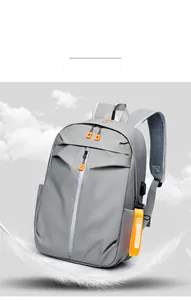 Lightweight grey waterproof backpack detail with USB port and orange fashion tag