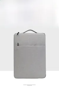 Vertical grey canvas laptop sleeve with top handle and front zipper pocket detail