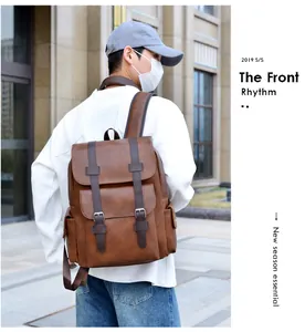 Detail view of large brown vintage PU leather backpack with silver metallic buckles