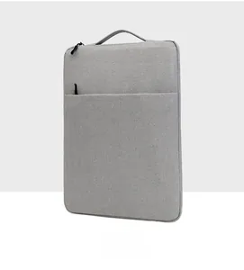 Slim light gray laptop sleeve featuring a top handle and front zipper pocket detail