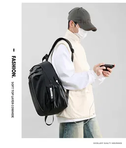 Detail view of the USB charging port and cowhide texture on the black backpack