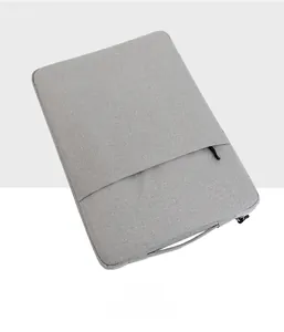 Waterproof grey laptop sleeve detail showing front zipper pocket and side handle