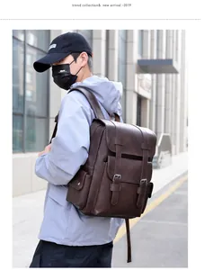 Close-up of vintage brown PU leather backpack with buckle straps in urban street setting