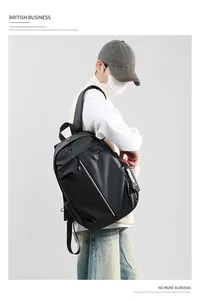 Side view of a waterproof black backpack with reflective strips on a male model