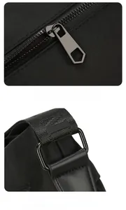 Detail of durable metal D-ring and smooth zipper on black Oxford fabric crossbody bag