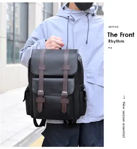 Detailed view of large capacity black PU leather travel backpack with brown straps