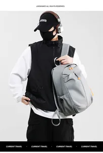 Grey waterproof backpack detail with orange contrast zipper pullers and mesh side pockets