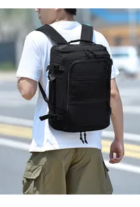 Detailed view of black multi-layer travel backpack with side buckles and breathable mesh pocket