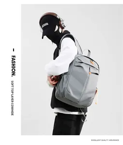 Macro detail of waterproof grey backpack with orange zipper accents and leather trim