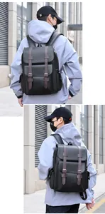 Detail view of the retro leather backpack showing the black pebble texture and side pocket